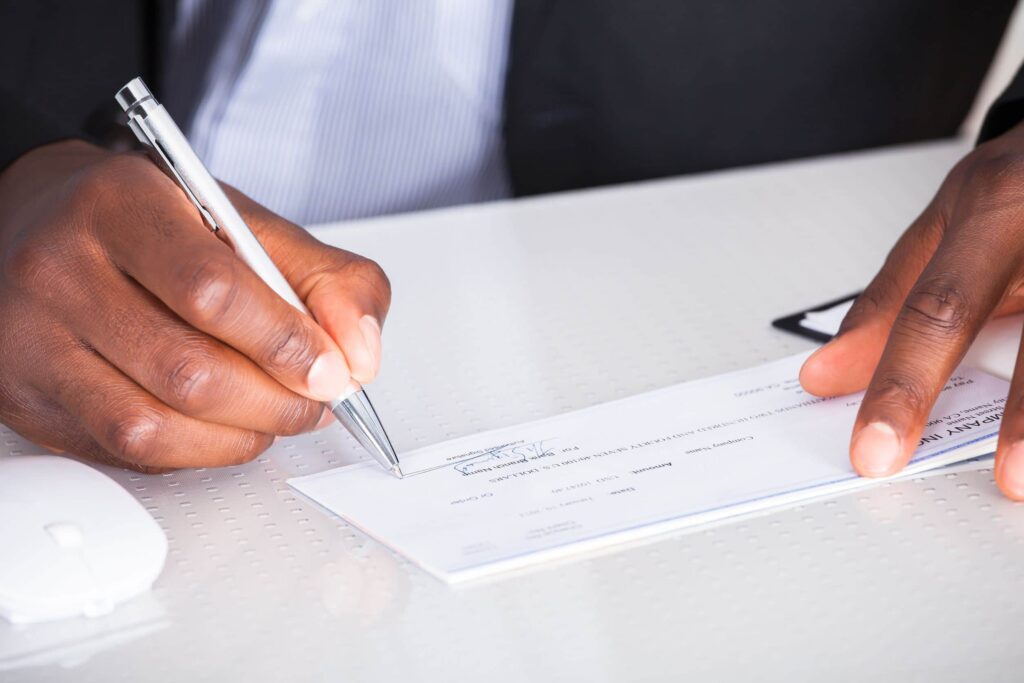man writing check