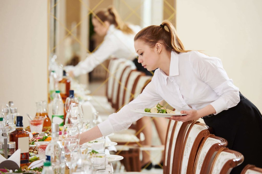 waitress serving banquet table