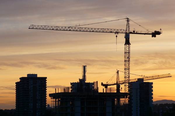 crane silhouette during sunset over a city skyline