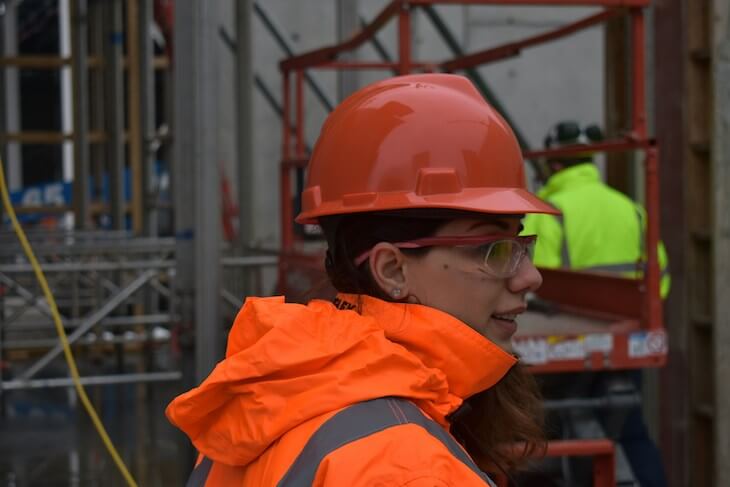 female construction worker in red hardhat