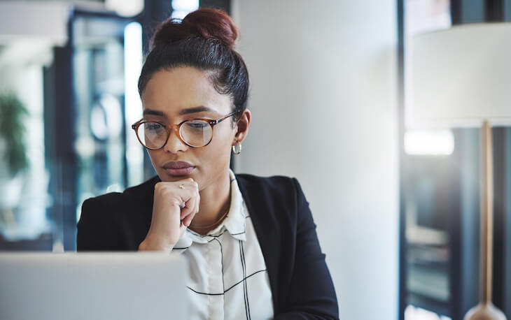 professional woman works on laptop